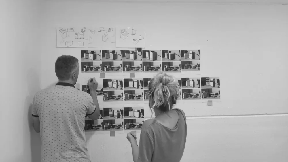 Sketches and reference photos on the study wall.