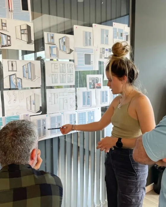 Reviewing sketches on the study wall.