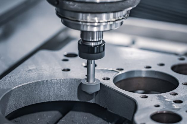 Metalworking CNC milling machine. Cutting metal modern processing technology. Small depth of field. Warning - authentic shooting in challenging conditions. A little bit grain and maybe blurred.